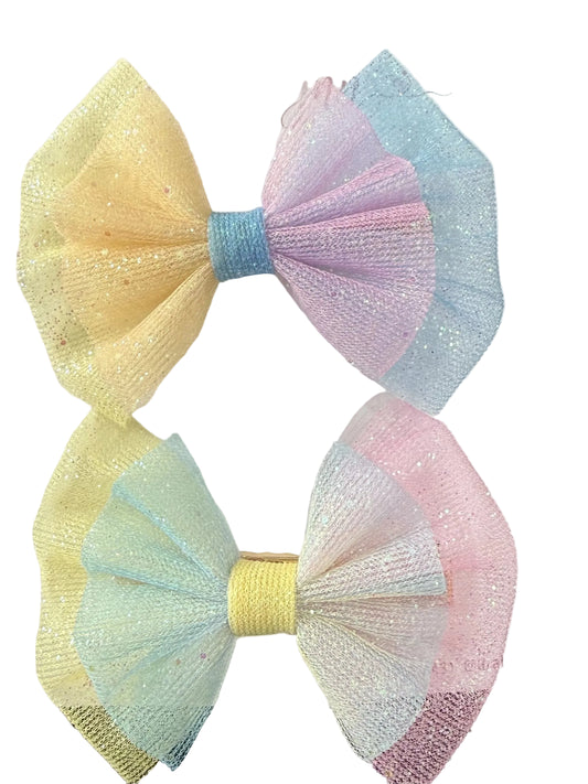 Set of two handmade pastel glitter tulle boutique hair bows in yellow, pink, blue, and white for babies, toddlers, and girls.