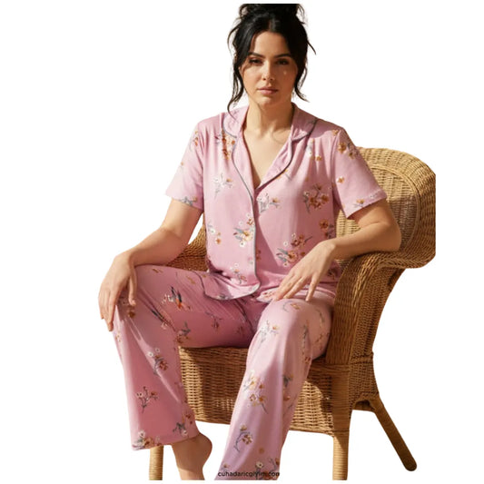 Women's soft pink floral short-sleeve button-up pajama set with matching full-length pants.