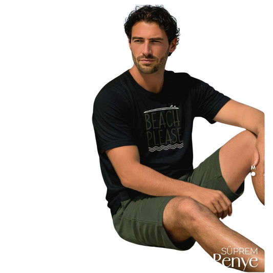 Man wearing a black 100% cotton short-sleeve pyjama set with “Beach Please” print T-shirt and olive green shorts, breathable and comfortable men's summer sleepwear available at Aroma Garden Lebanon.