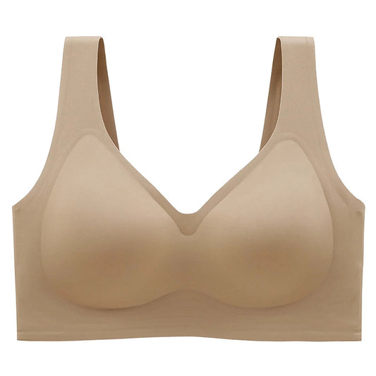 A seamless, wireless bra in a light beige/nude color, shown flat against a solid white background.